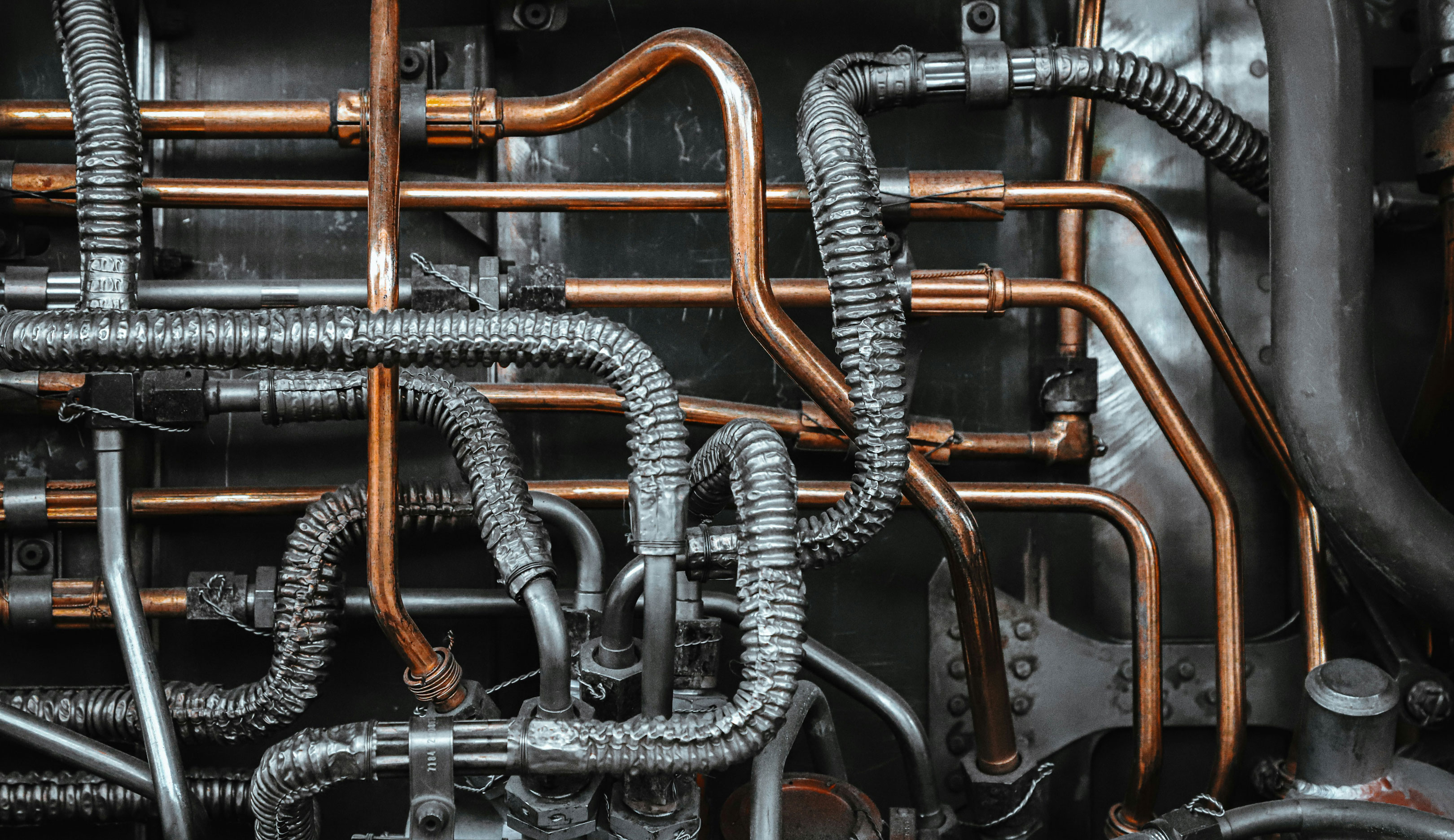 copper, alloy, and corrugated pipes entangled in a tight, intricate system of various directions and orientations